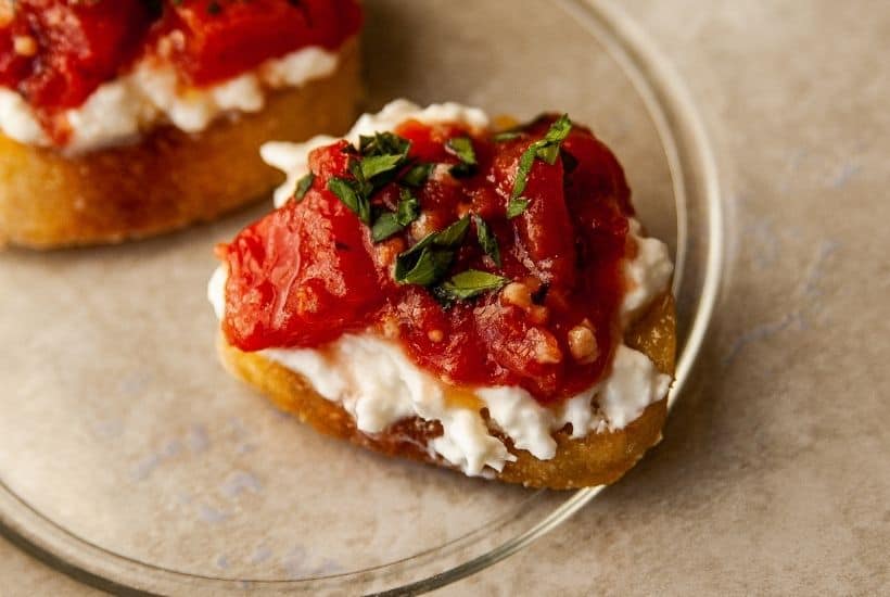 Need a quick appetizer recipe? Try this easy Burrata And Fire Roasted Tomato Bruschetta for your next party or gathering. Your guest will love this easy bruschetta recipe.