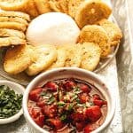 Need a quick appetizer recipe? Try this easy Burrata And Fire Roasted Tomato Bruschetta for your next party or gathering. Your guest will love this easy bruschetta recipe.