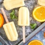 Orange Julius Popsicles are creamy, smooth, and full of orange flavor. If you love an orange creamsicle, you are going to love this variation of the classic frozen treat. This Copycat Orange Julius Pops Recipe is perfect for a hot summer day. Try this homemade orange creamsicle recipe today.
