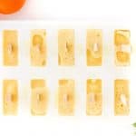 Orange Julius Popsicles are creamy, smooth, and full of orange flavor. If you love an orange creamsicle, you are going to love this variation of the classic frozen treat. This Copycat Orange Julius Pops Recipe is perfect for a hot summer day. Try this homemade orange creamsicle recipe today.