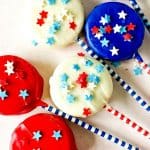 Patriotic Oreo Pops are a fun red, white and blue snack recipe to celebration the 4th of July or Memorial Day. Show you patriotic spirit and whip of a batch of these quick and easy cookie snacks.
