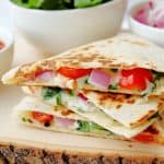 Use this Mediterranean Quesadillas recipe to prepare a cheesy meat-free meal full of fresh vegetables. These quesadillas are perfect to eat for breakfast, lunch, or dinner! This easy quesadilla recipe is a delicious meatless meal idea. It's a perfect sandwich recipe for lunch or dinner.
