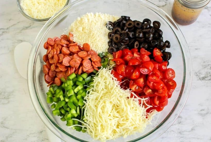 Easy Pepperoni Pasta Salad is a cold pasta salad recipe filled with pepperoni, cheese, vegetables and homemade Italian dressing. This zesty pepperoni pasta salad is perfect for potlucks, summer BBQs and large crowds! This really is the best cold pasta salad recipe!