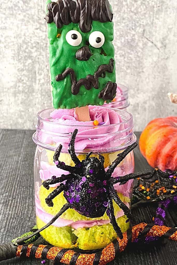 Cute and spooky, these easy Frankenstein Cupcakes In A Jar are perfect for a Halloween party. This kid-friendly Halloween recipe is made from doctored-up box cake mix and topped with a Frankenstein Rice Krispies treat.