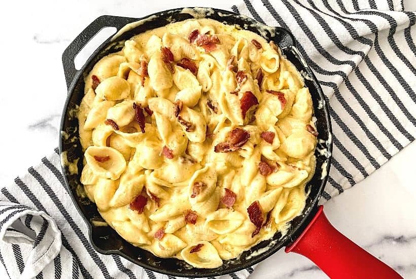 Ditch the box of macaroni and cheese and make a cheesy side on the stovetop with this stovetop Bacon Mac and Cheese recipe. It’s simple, flavorful, and perfect to serve with some of your favorite entrees, such as chicken and pork! This stovetop macaroni and cheese recipe is a perfect weeknight meal idea. Your family will love this creamy mac and cheese recipe. This is the mac & cheese is the ultimate comfort food recipe.