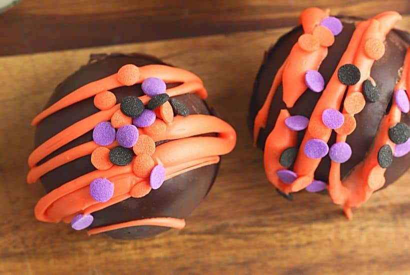 Fall is in the air and that calls for a warm treat. These Halloween Hot Cocoa Bombs are a perfect way to celebrate fall. Hot cocoa bombs for fall are filled with hot chocolate mix, miniature marshmallows and are nestled inside a delicious chocolate shell.