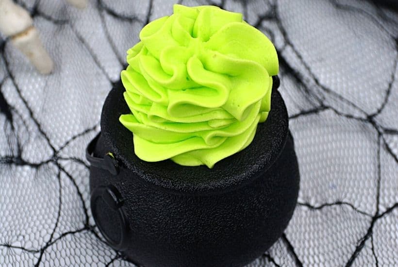 These bewitching Minnie Mouse Cauldron Cakes are a fun Halloween cupcake recipe to serve. You'll love this easy Halloween treat recipe. Disney fans will love making this easy cupcake recipe to celebrate Halloween and Disney. Minnie Mouse dressed in her best witch hat adorns the top of these mini-cauldron cakes. It's a fun Disney Halloween treat for kids or to make for a Halloween Party.