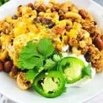 Prepare a fulfilling meal for the family with this wholesome and hearty Chili Mac. Loaded with flavor, this easy comfort food recipe is perfect to make for lunch or dinner with a side of cornbread or garlic bread! Chili Mac and Cheese is an easy weeknight meal idea.