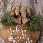 Make a decorative piece to hang in your home with this easy winter craft idea. Make a DIY Farmhouse Winter Sign that will add a special touch to any room in the home. This Christmas Cricut craft is a great project to make. It can be left up long after Christmas is over. Be sure to download the FREE SVG file - Baby It's Cold Outside too. Hang this sign on your entryway door or on a wall in your home.