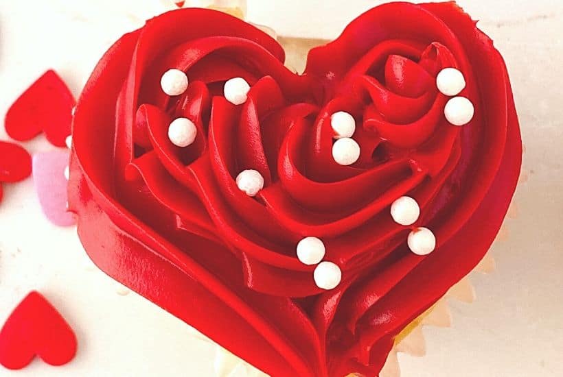 These red heart cupcakes are perfect for Valentine's Day. Learn how to make easy heart-shaped cupcakes to share with family and friends. I also share my best tips on how to freeze cupcakes in this post as well. This easy Valentine cupcake recipe is sure to win the hearts of your family and friends.