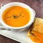 Satisfy your craving for something comforting and flavorful with this delicious Roasted Tomato Soup. Not only is it full of flavor, but it’s also easy to prepare and perfect for lunch, dinner, or even an appetizer. This easy homemade tomato soup recipe goes perfectly with a grilled cheese sandwich. This easy soup recipe is perfect for your lunch or dinner meal plan. It's the ultimate comfort food recipe.