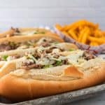 Enjoy the fresh flavor of a thinly sliced steak with cheese, onions, and peppers on rolls with this recipe for homemade Philly Cheesesteaks. If you’ve ever visited Philly (or any of the towns surrounding Philadelphia), you know that they are best known for the famous Philly Cheesesteak. This easy cheesesteak recipe is great to have for lunch and dinner.