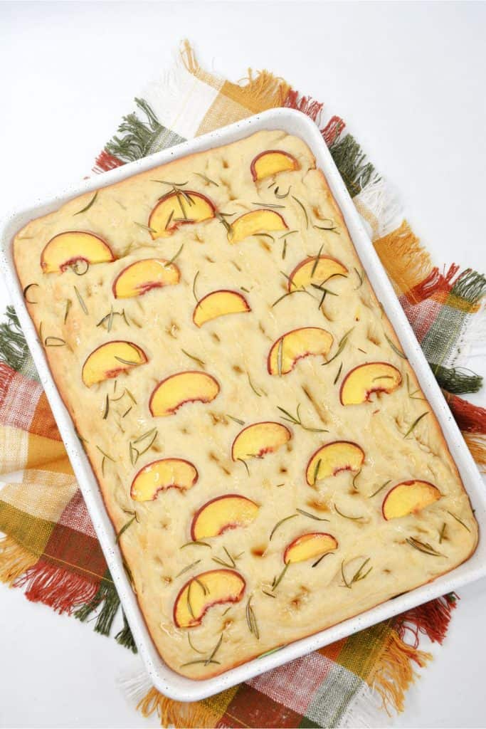 Prepare a light and refreshing treat with this delicious Peach & Rosemary Focaccia Bread. It has the perfect naturally sweet touch with peaches, making it the perfect quick snack to enjoy! Focaccia bread, the Italian-style bread. With this recipe for Peach & Rosemary Focaccia Bread, you’re combining two incredible flavors into one to make bread that has a light, sweet taste and amazing texture that keeps you coming back for more.