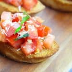 Bruschetta is a classic Italian appetizer that is easy to make at home. Toasted bread is topped with tomatoes, Parmesan cheese, garlic, and fresh basil.