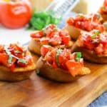 Bruschetta is a classic Italian appetizer that is easy to make at home. Toasted bread is topped with tomatoes, Parmesan cheese, garlic, and fresh basil.