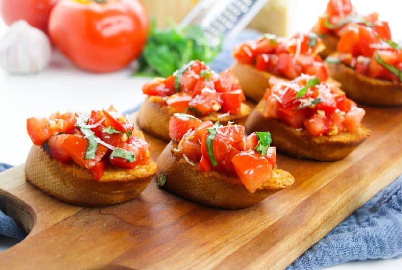 Bruschetta is a classic Italian appetizer that is easy to make at home. Toasted bread is topped with tomatoes, Parmesan cheese, garlic, and fresh basil.