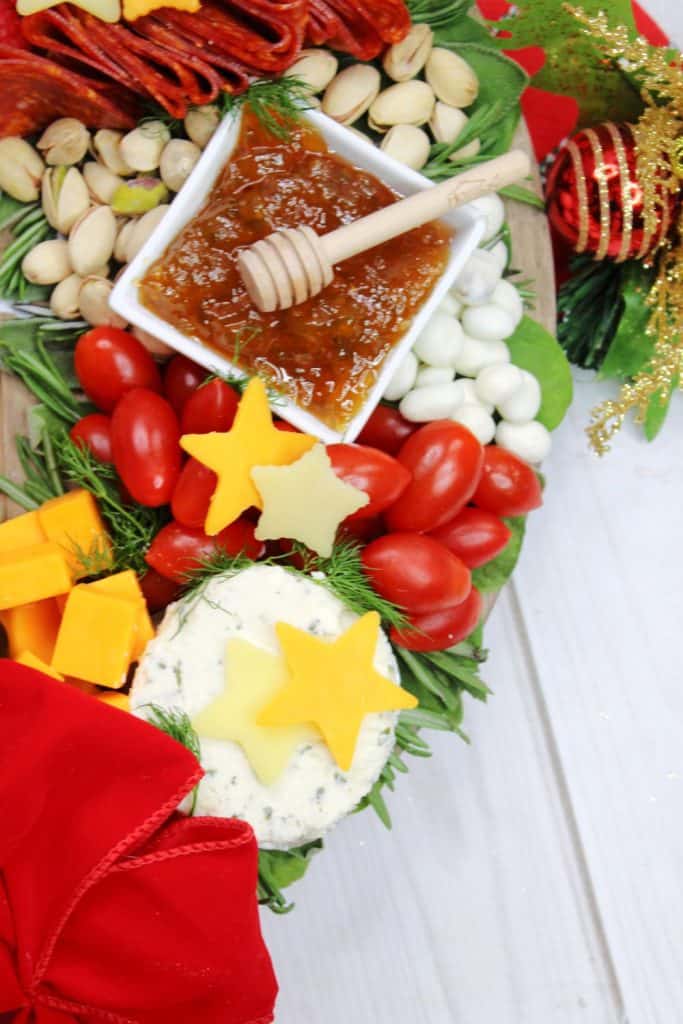 Charcuterie boards are a great party appetizer idea, especially during the holiday season. This festive, and delicious Christmas Wreath Charcuterie Board will wow your guests for the holidays.