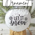 Who says you need the most expensive ornaments to make your Christmas tree look amazing? Learn how to easily create the most beautiful Let It Snow Ornament to hang on the tree or give as a gift. This DIY Ornament is an easy holiday Cricut Craft Idea. It is a great homemade Christmas gift craft idea.