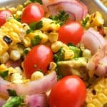 Ditch the typical pasta salad and go for something lighter and refreshing with this delicious grilled Corn Tomato Salad recipe. It’s the perfect summer side to serve. This easy summer salad pairs two stars of the season - corn and tomatoes, making this healthy salad recipe a winner.