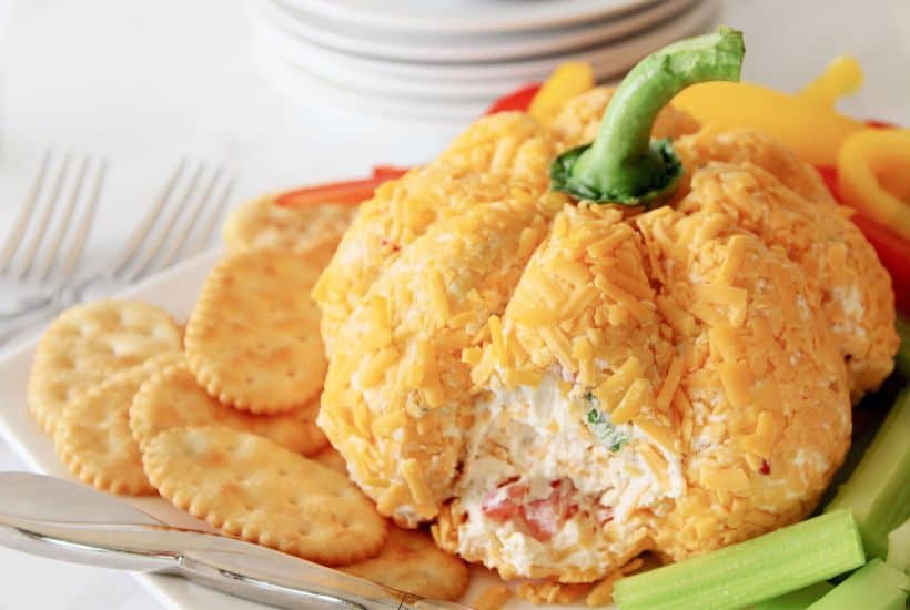 Prepare the perfect fall appetizer for family and friends with this Pumpkin Shaped Cheeseball. It looks just as good as it tastes and is the ideal addition to your fall party menu. Dip some of your favorite foods into it to add that extra cheesy touch!