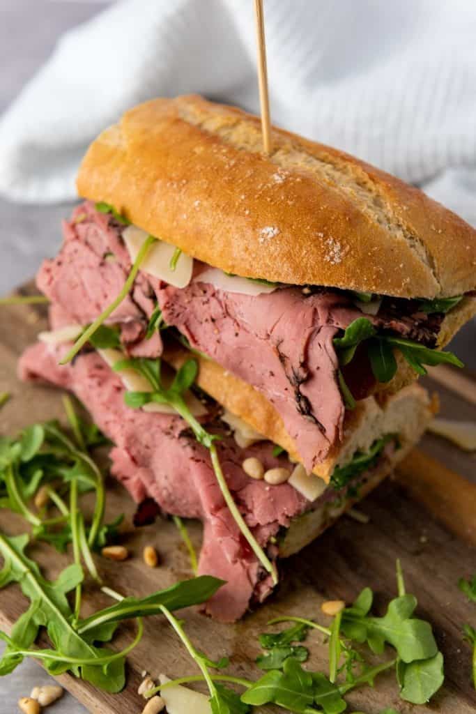 This Roast Beef Sandwich is no ordinary sandwich! With medium-rare roast beef, arugula, shaved parmesan, and roasted pine nuts, this roast beef sandwich is over-the-top delicious. And when you slather on that homemade truffle mayo it becomes absolute perfection.