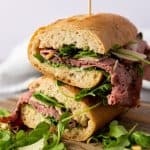 This Roast Beef Sandwich is no ordinary sandwich! With medium-rare roast beef, arugula, shaved parmesan, and roasted pine nuts, this roast beef sandwich is over-the-top delicious. And when you slather on that homemade truffle mayo it becomes absolute perfection.