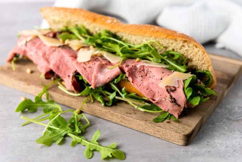 This Roast Beef Sandwich is no ordinary sandwich! With medium-rare roast beef, arugula, shaved parmesan, and roasted pine nuts, this roast beef sandwich is over-the-top delicious. And when you slather on that homemade truffle mayo it becomes absolute perfection.