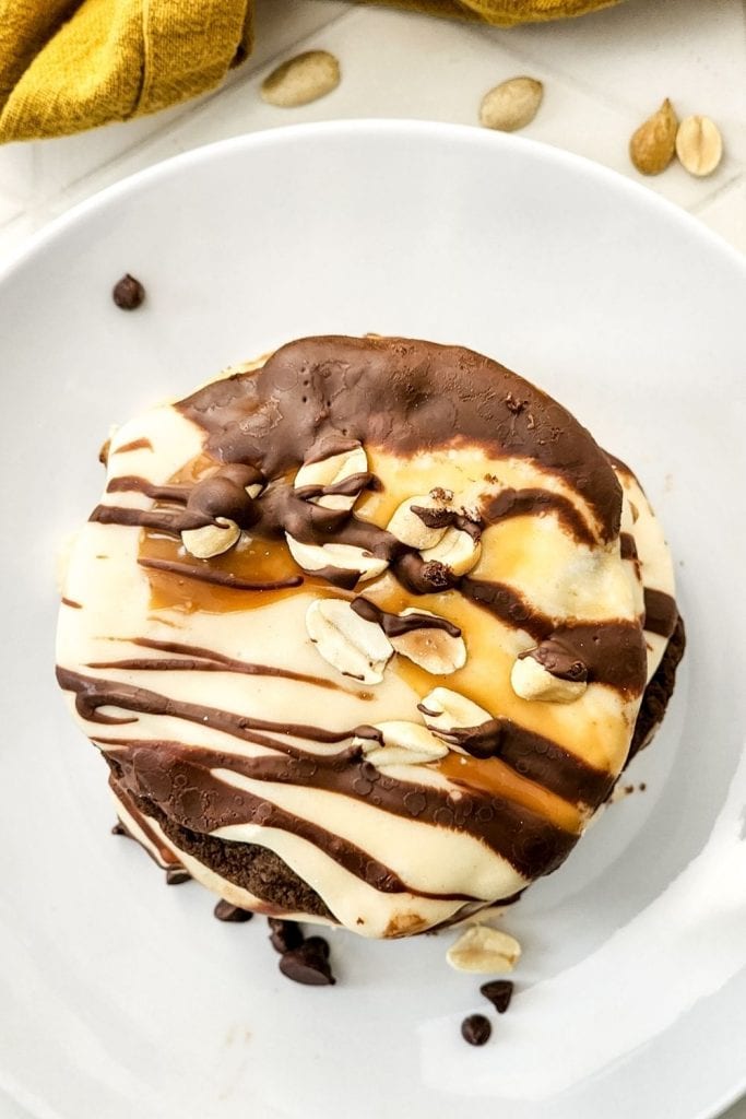 These Soft & Chewy Snickers Cookies are a delightful treat that has all the flavors of a Snickers bar. The double chocolate cookies are soft and chewy while the nougat whipped frosting adds a totally different chewy element. Topped with melted caramel, chocolate, and peanuts, these Snickers cookies truly are the perfect sweet treat.