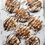 These Soft & Chewy Snickers Cookies are a delightful treat that has all the flavors of a Snickers bar. The double chocolate cookies are soft and chewy while the nougat whipped frosting adds a totally different chewy element. Topped with melted caramel, chocolate, and peanuts, these Snickers cookies truly are the perfect sweet treat.