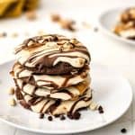 These Soft & Chewy Snickers Cookies are a delightful treat that has all the flavors of a Snickers bar. The double chocolate cookies are soft and chewy while the nougat whipped frosting adds a totally different chewy element. Topped with melted caramel, chocolate, and peanuts, these Snickers cookies truly are the perfect sweet treat.