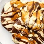 These Soft & Chewy Snickers Cookies are a delightful treat that has all the flavors of a Snickers bar. The double chocolate cookies are soft and chewy while the nougat whipped frosting adds a totally different chewy element. Topped with melted caramel, chocolate, and peanuts, these Snickers cookies truly are the perfect sweet treat.