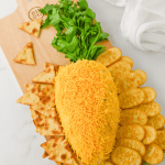 Get ready to wow your guests this Easter with the most adorable and delicious carrot-shaped Easter Cheese Ball! This whimsical Carrot Cheeseball appetizer is sure to steal the show with its festive carrot shape and irresistible flavors. Learn how to turn a simple cheese ball recipe into a great make-ahead appetizer for your Easter Dinner.