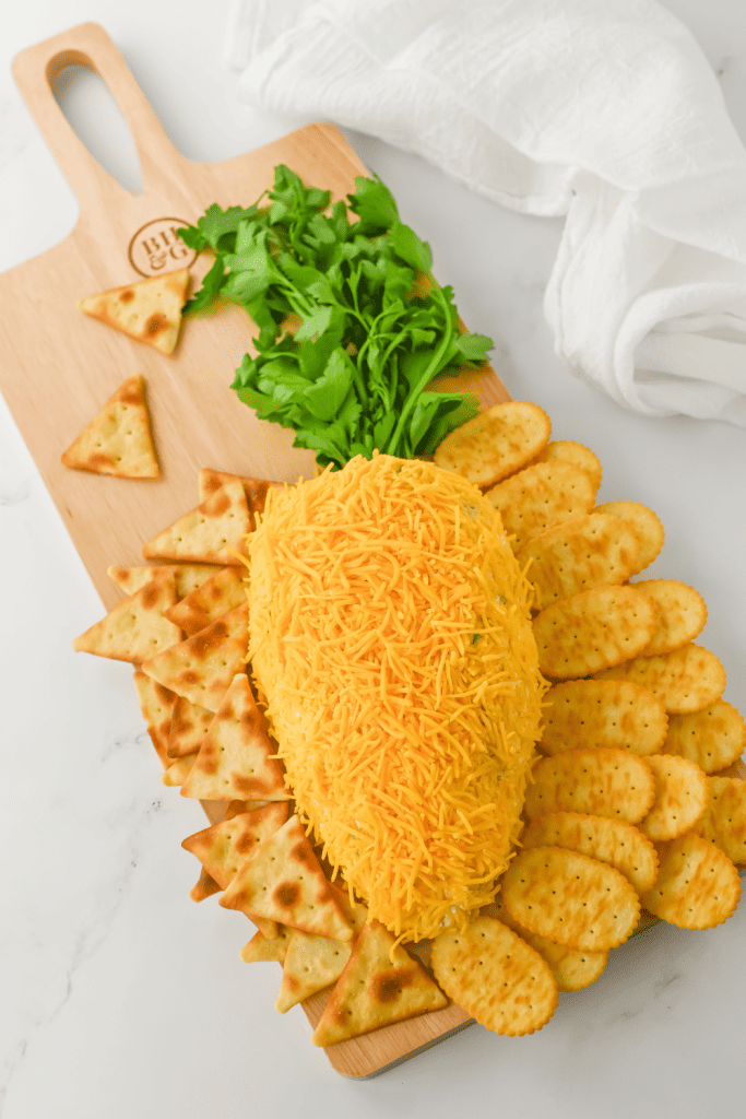 Get ready to wow your guests this Easter with the most adorable and delicious carrot-shaped Easter Cheese Ball! This whimsical Carrot Cheeseball appetizer is sure to steal the show with its festive carrot shape and irresistible flavors. Learn how to turn a simple cheese ball recipe into a great make-ahead appetizer for your Easter Dinner.