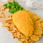 Get ready to wow your guests this Easter with the most adorable and delicious carrot-shaped Easter Cheese Ball! This whimsical Carrot Cheeseball appetizer is sure to steal the show with its festive carrot shape and irresistible flavors. Learn how to turn a simple cheese ball recipe into a great make-ahead appetizer for your Easter Dinner.
