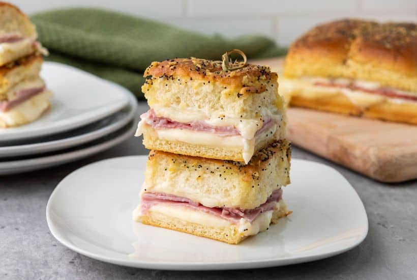 These Ham and Cheese Hawaiian Sliders are the ultimate party appetizers! Sweet Hawaiian rolls packed with savory ham, melty Swiss cheese, and a deliciously sweet and tangy glaze. This classic recipe is a family favorite.