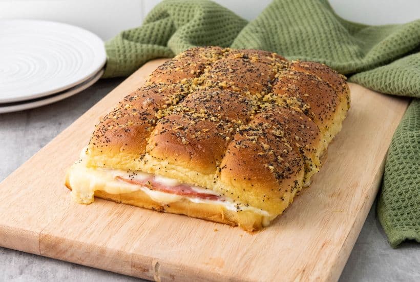 These Ham and Cheese Hawaiian Sliders are the ultimate party appetizers! Sweet Hawaiian rolls packed with savory ham, melty Swiss cheese, and a deliciously sweet and tangy glaze. This classic recipe is a family favorite.