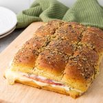 These Ham and Cheese Hawaiian Sliders are the ultimate party appetizers! Sweet Hawaiian rolls packed with savory ham, melty Swiss cheese, and a deliciously sweet and tangy glaze. This classic recipe is a family favorite.