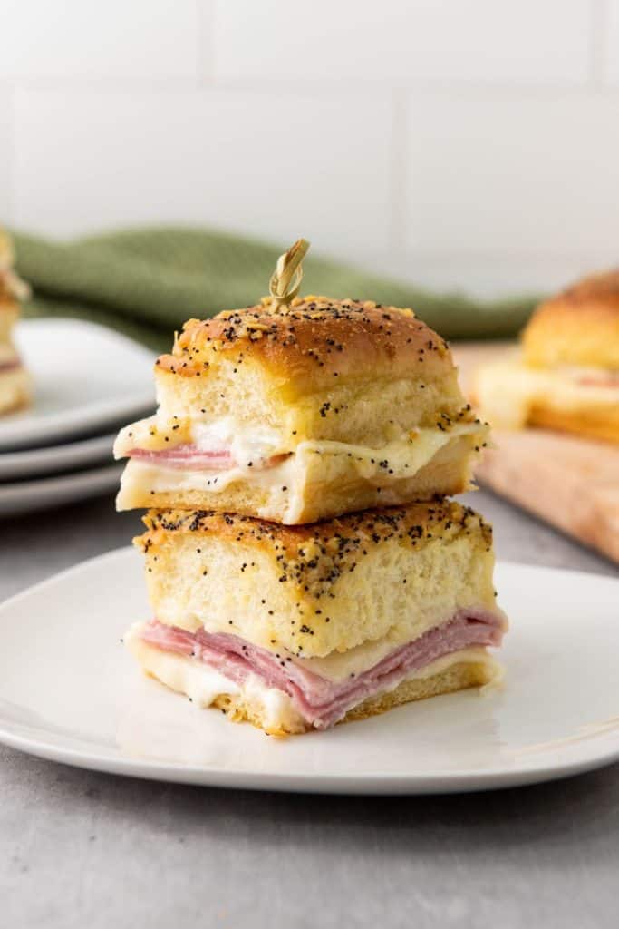 These Ham and Cheese Hawaiian Sliders are the ultimate party appetizers! Sweet Hawaiian rolls packed with savory ham, melty Swiss cheese, and a deliciously sweet and tangy glaze. This classic recipe is a family favorite.
