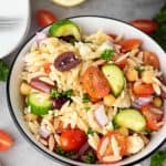 When it comes to side dishes, this simple Greek Orzo Salad is one of my family's favorite recipes. No cookout is complete without this healthy pasta salad recipe full of Greek flavor.