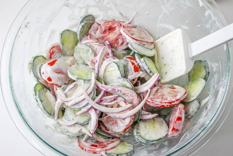 If you're in the mood for a light and refreshing side dish, this Creamy Tomato and Cucumber Salad is just what you need. It's a simple combination of sliced tomatoes, cucumbers, and red onion, all tossed in a creamy, tangy dressing.