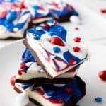 If you're looking for a fun and festive dessert to celebrate your patriotic spirit, this Red, White, and Blue Chocolate Bark is the perfect treat. It's a simple, no-bake recipe that combines the rich flavors of white and semi-sweet chocolate with bright colors that make it perfect for any American holiday!