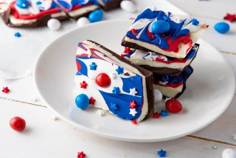 If you're looking for a fun and festive dessert to celebrate your patriotic spirit, this Red, White, and Blue Chocolate Bark is the perfect treat. It's a simple, no-bake recipe that combines the rich flavors of white and semi-sweet chocolate with bright colors that make it perfect for any American holiday!