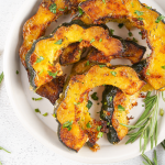 These Roasted Acorn Squash Slices are a super tasty, quick, and easy side dish. With few ingredients and minimal cook/prep time, this fall dish is great as a last-minute addition. The rich flavors of acorn squash are heightened by the aromatic herbs and brought full circle with the addition of parmesan and seasonings.