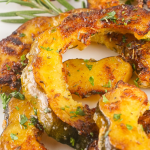 These Roasted Acorn Squash Slices are a super tasty, quick, and easy side dish. With few ingredients and minimal cook/prep time, this fall dish is great as a last-minute addition. The rich flavors of acorn squash are heightened by the aromatic herbs and brought full circle with the addition of parmesan and seasonings.